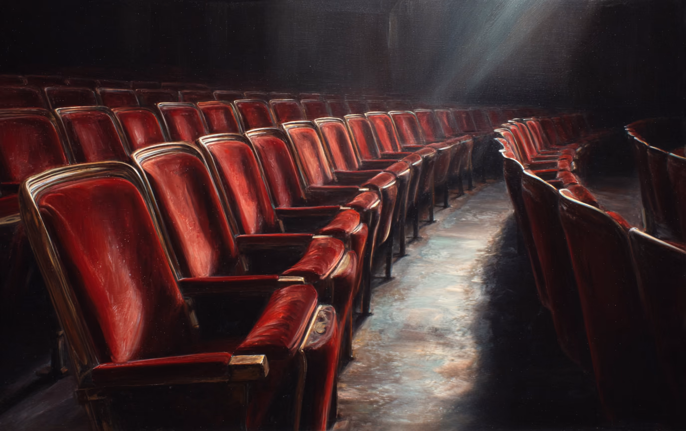 A painting of empty red theatre seats in rows, lit only by the spill from an unseen screen.